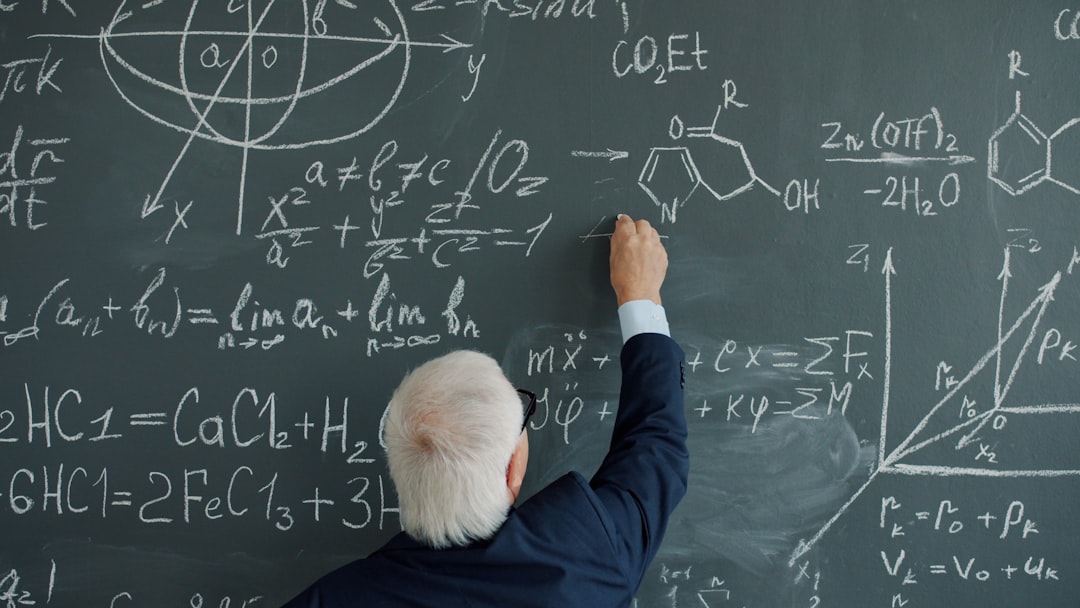 Marketing strategist sketches a hub-and-spoke content cluster diagram on a modern glass whiteboard, symbolizing a structur...