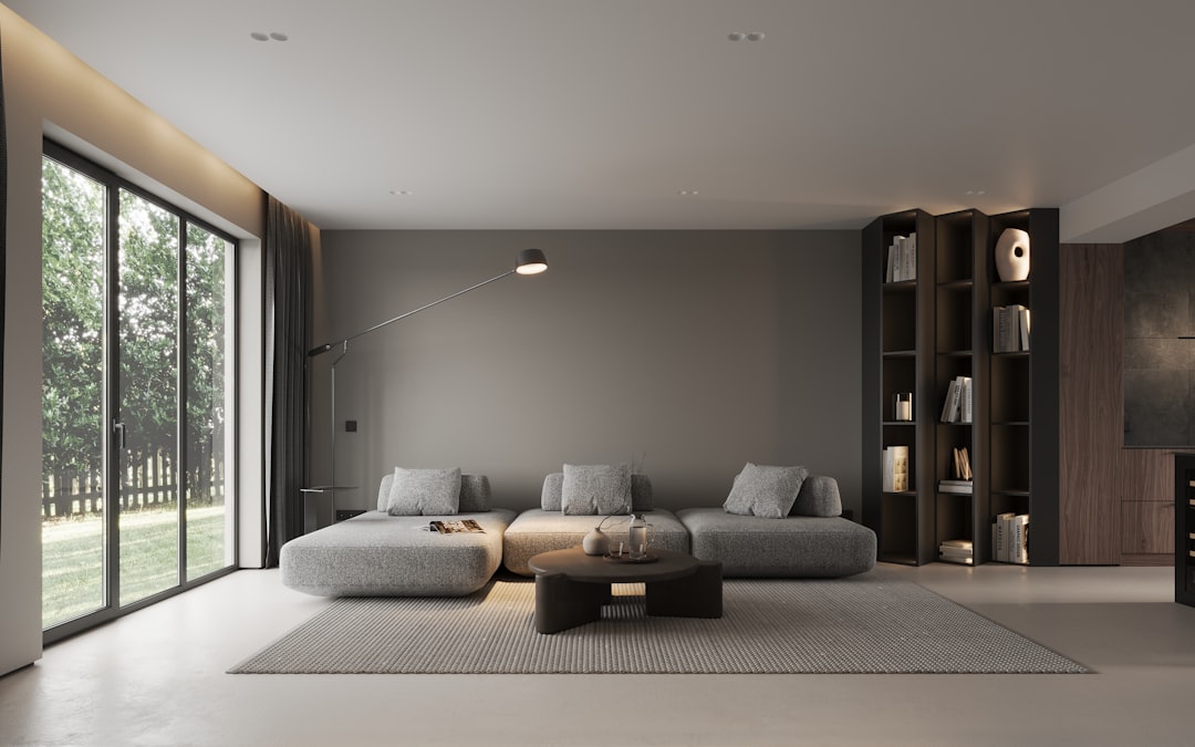 A bright, professionally staged modern living room with clean lines and large windows, showcasing the high-quality digital marketing of a luxury real estate listing.