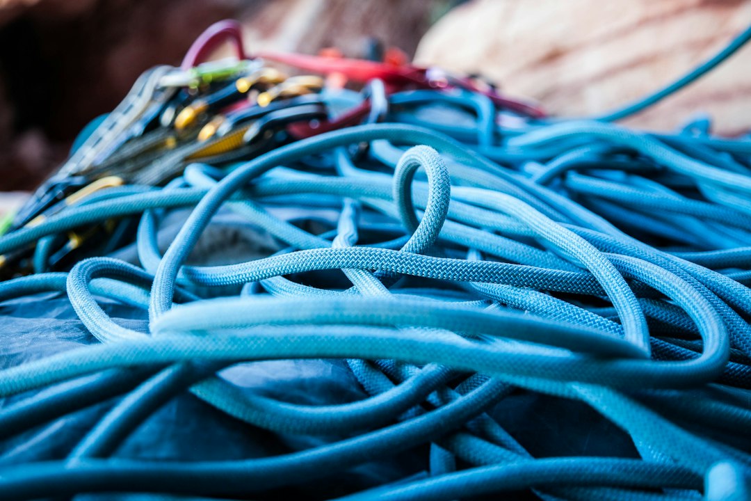 A close-up of a dusty and disorganized bundle of tangled server cables, symbolizing an outdated and inefficient technology infrastructure.